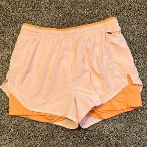 Nike Women's Athletic Shorts peach color.